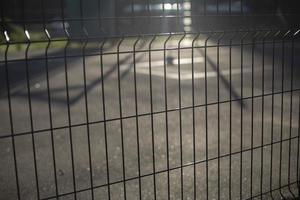 Fence on sports ground in sunlight. Stadium details. Sports ground in morning. photo