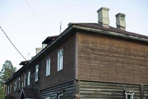 Old house made of boards. Emergency housing in Russia. Details of construction. photo
