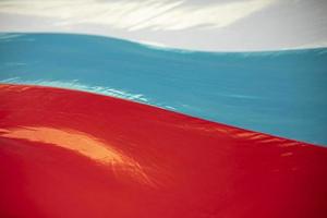 Flag of Russia in waves. Vibration of fabric in wind. Colors of national flag. photo