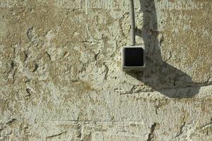 Wall switch. Button for light. Wire to button. Wall with switch. photo