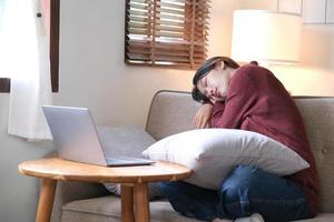 young asian woman sleeping break time or off line mode after using laptop relax sitting on couch or sofa, people lifestyle at home, digital detox concept photo