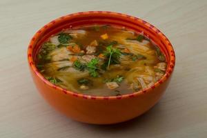 Soup Pho in a bowl on wooden background photo