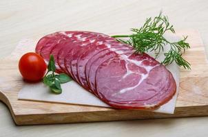 Sliced Ham on wooden board and wooden background photo