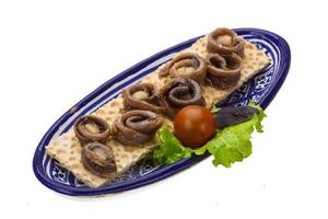 Anchovy snack in a bowl on white background photo