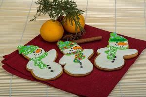 Christmas gingerbread on wooden background photo