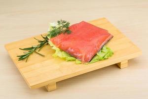 Salted salmon on wooden board and wooden background photo