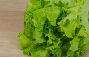 Salad leaves on wooden background photo