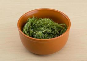 Chuka salad in a bowl on wooden background photo