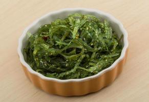 Chuka salad in a bowl on wooden background photo