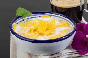 Cornflakes in a bowl on wooden background photo