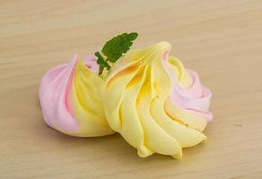 Meringue on wooden background photo