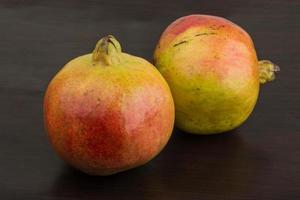 Yellow Pomegranet on wooden background photo