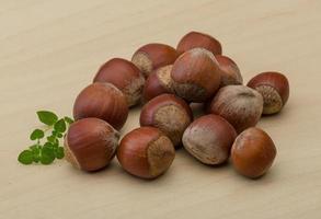 Hazelnut heap on wooden background photo