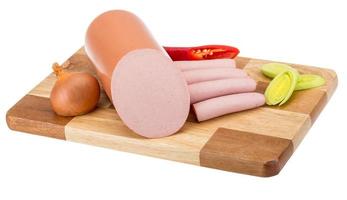 Sausages on wooden board and white background photo