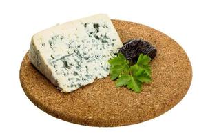 Blue cheese on wooden board and white background photo