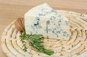 Blue cheese on wooden board and wooden background photo