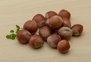 Hazelnut heap on wooden background photo