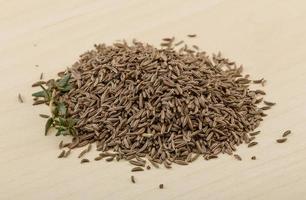 Dry caraway on wooden background photo