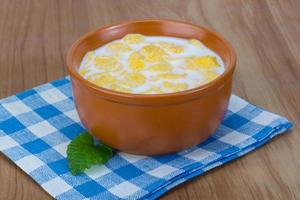 Cornflakes in a bowl on wooden background photo