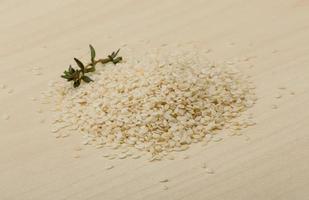 Sesame seeds on wooden background photo