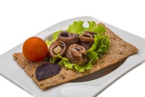 Anchovy snack in a bowl on white background photo