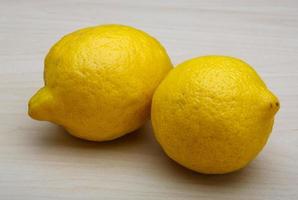 Lemons on wooden background photo