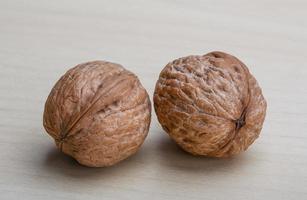 Walnuts on wooden background photo