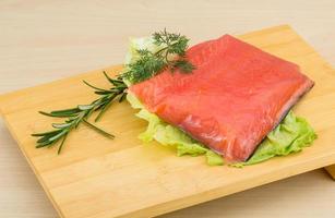 Salted salmon on wooden board and wooden background photo