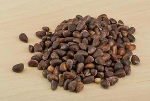 Cedar nut on wooden background photo