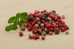 Pepper mix on wooden background photo