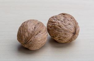 Walnuts on wooden background photo