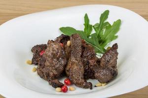 Roasted venison on the plate and wooden background photo