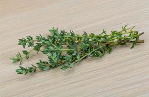 Fresh thyme on wooden background photo