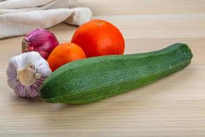 Zuchini on wooden background photo