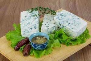 Blue cheese on wooden board and wooden background photo