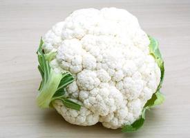 Cauliflower on wooden background photo