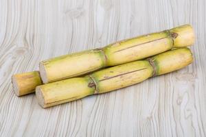 Sugar reed on wooden background photo