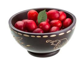 Damson plum in a bowl on white background photo