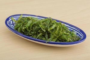 Chuka salad in a bowl on wooden background photo