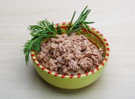 Cannded runa in a bowl on wooden background photo