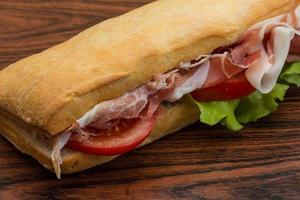 Ham sandwich on wooden background photo