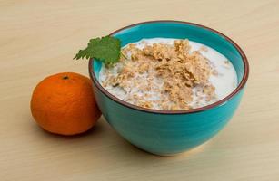 Cornflakes in a bowl on wooden background photo