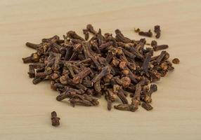 Clove seeds on wooden background photo