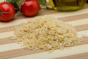 ABC macaroni on wooden board and wooden background photo