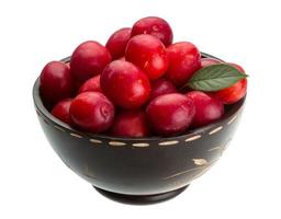 Damson plum in a bowl on white background photo