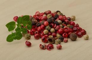 Pepper mix on wooden background photo