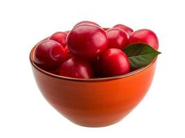 Damson plum in a bowl on white background photo