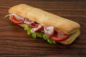 Ham sandwich on wooden background photo