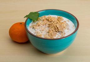 Cornflakes in a bowl on wooden background photo