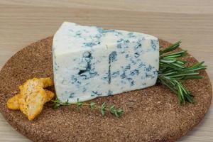 Blue cheese on wooden board and wooden background photo